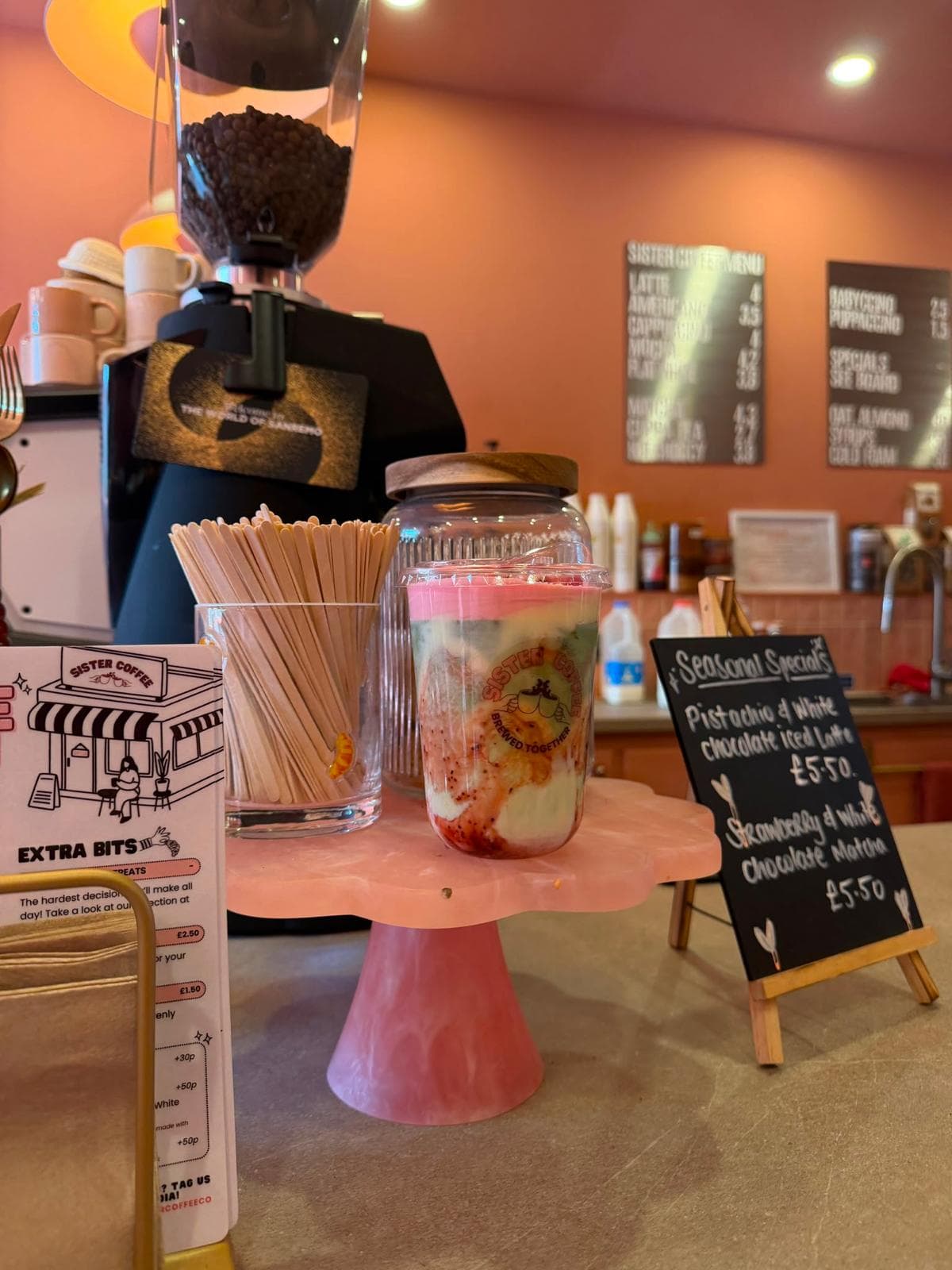 The counter with the seasonal specials board and an iced drink